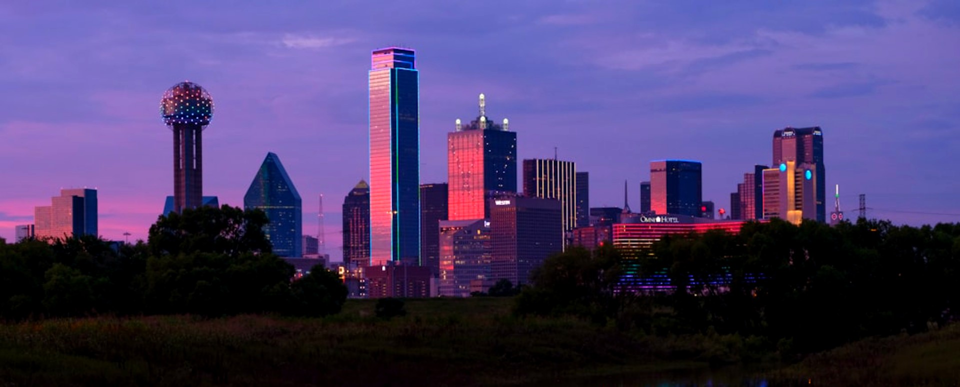 Dallas skyline at sunset across the Trinity River